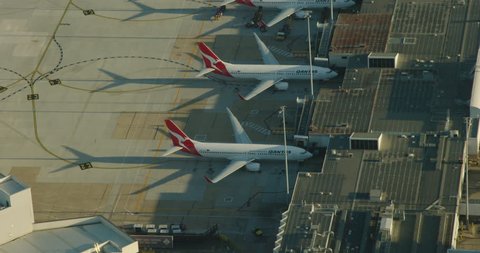 Melbourne Australia - March 2018: Aerial sunrise view Qantas aircraft for visitors and business commuters parked at Melbourne airport terminal Tullamarine Victoria Australia