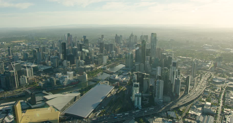 Aerial sunrise view morning traffic travelling along West Gate Freeway around Melbourne CBD by Yarra River Victoria Australia
