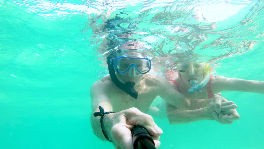 Selfie portrait of happy Caucasian American male and female seniors snorkeling making video diary underwater in turquoise sea Bahamas America | Shutterstock HD Video #1018447219