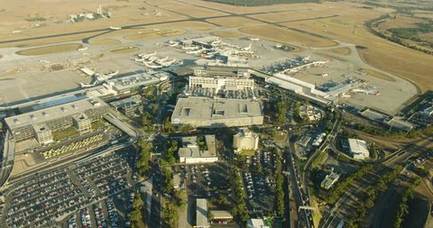 Melbourne Australia - March 2018: Aerial sunrise view vehicles and aircraft parked and travelling around Melbourne international airport passenger terminal Tullamarine Victoria Australia