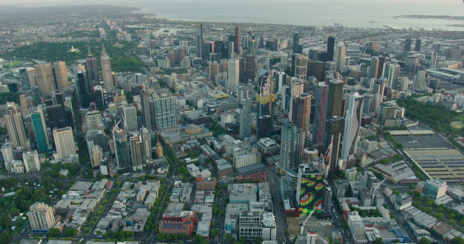 Aerial view at sunset across Melbourne central business district offices and skyscrapers to Port Phillip Bay Victoria Australia
