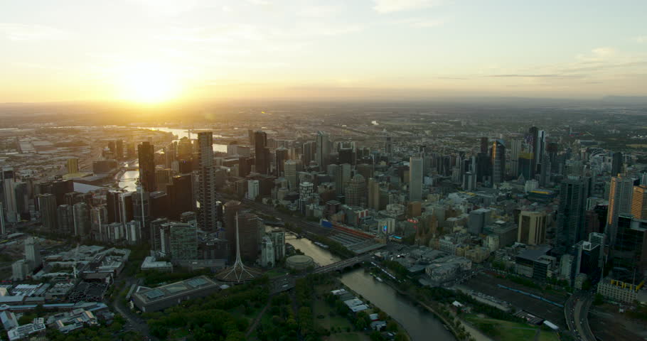 Aerial cityscape view evening sunset over Melbourne CBD with Yarra River and Port Phillip Bay Victoria Australia