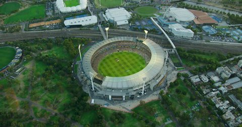 Aerial view at sunset Melbourne Cricket Ground sports stadium with illuminated light towers Yarra Park Victoria Australia