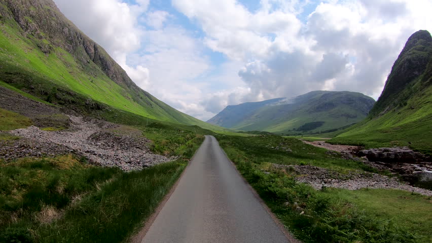 POV journey driving in Glen Etive scenic evergreen pine forest Scottish highland landscape mountain slopes rural valley wilderness Scotland UK Europe 
