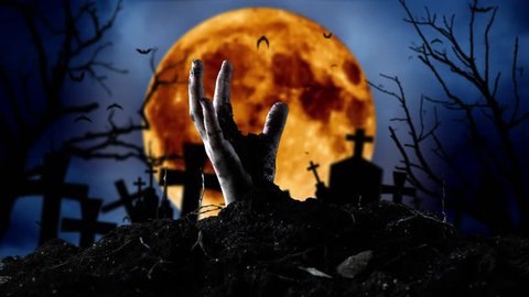 Zombie hand comes out of the grave and bats fly. Graveyard background