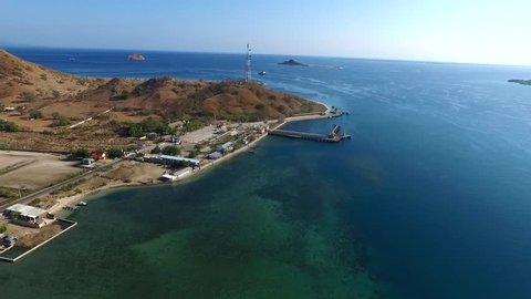 SUMBAWA INDONESIA, OCTOBER 26 2018 : Aerial Pototano Harbour, Ferry Ship departure from Lombok to Sumbawa with arid mountain scenery and gorgeous blue sky