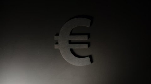 Moving light illuminates Euro symbol