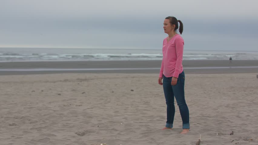 Woman in a Pink Shirt Trying to Catch on the Oregon Coast