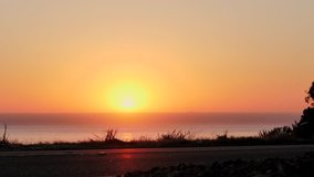 traffic on coastal highway at sunset. Two cars drive by - Powered by Shutterstock - Get 15% off with code: PIKWIZARD15