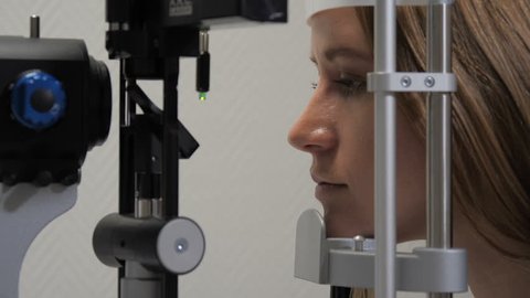 The patient is examined for vision on an ophthalmoscope on a close-up