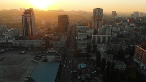 Aerial footage of the soccer stadium on the sunset in the big city. Big football arena in the evening. Empty stadium aerial footage.