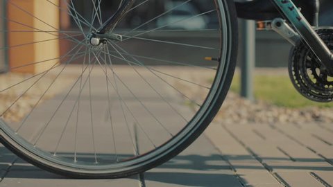 Close up cycling road bicycle outdoors fitness steadicam shot transportation speed fit person sun sport bike ride active action cyclist health lifestyle male man adult biker slow motion