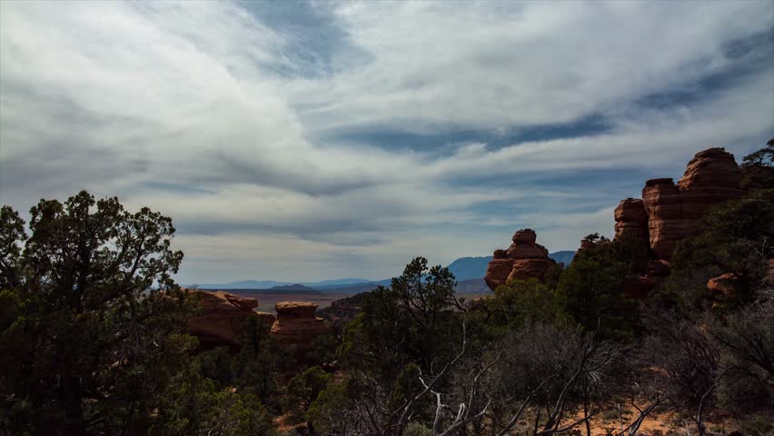 Timelapse of the moving clouds and sunset over red rock formations near Zions National Park, Utah