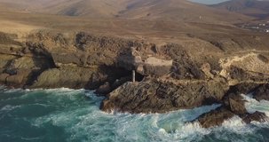 Drone video. Sunset light in bay of Ajuy. Caves and ruins of historic calcium mine on west shore of Fuerteventura island. Canary Islands. Spain.