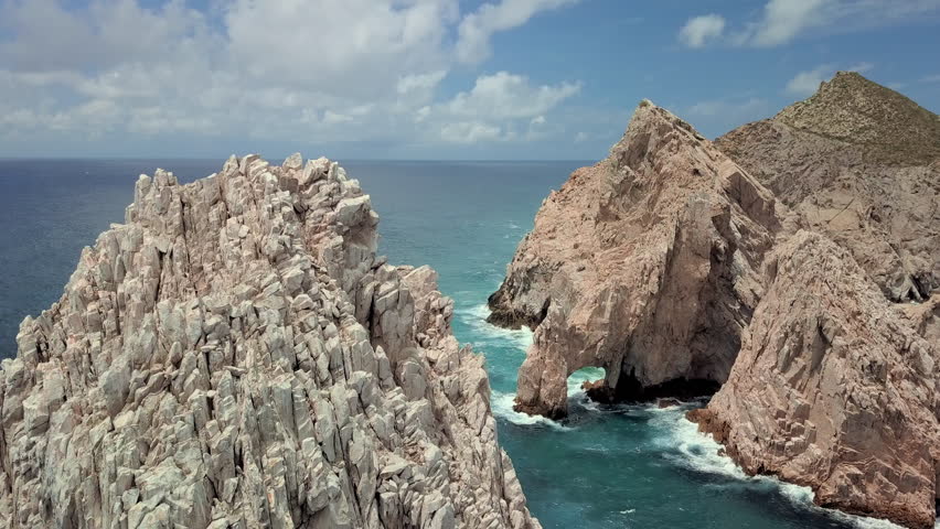 Aerial Descending Backward: Huge Arch Rock formations in Cabo