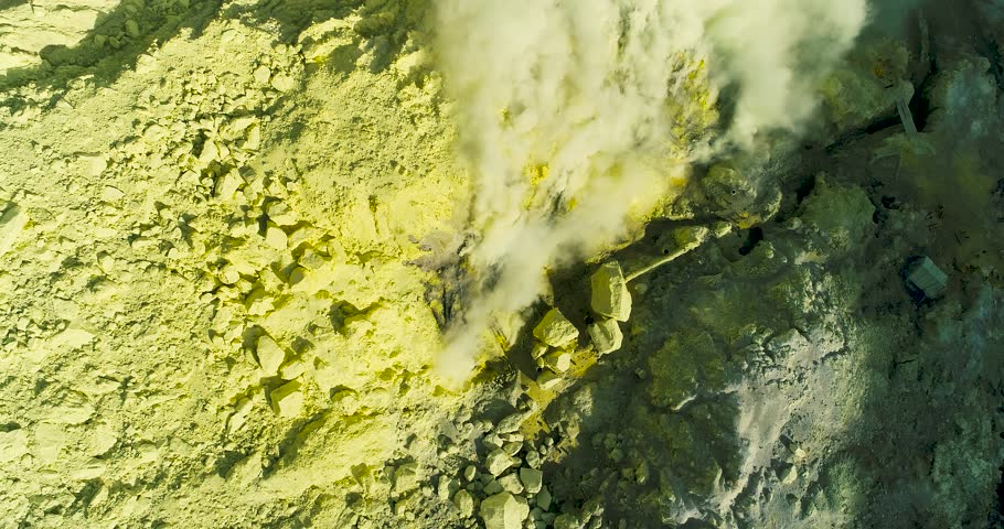 Aerial view of crater Ijen volcano with evaporation of sulfur dioxide gas where sulfur is mined. 4K