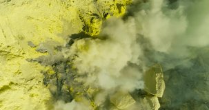 Aerial view of crater Ijen volcano with evaporation of sulfur dioxide gas where sulfur is mined. 4K