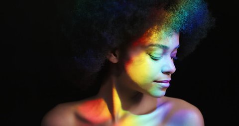 multicolor portrait beautiful woman with funky afro smiling confident enjoying individual expression natural feminine beauty colorful light on black background lgbt pride concept
