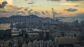 4K City Timelapse video of Hong Kong . Wide and high angle view from the Peak of mountain . Office buildings and busy traffic under clear sky at day and night