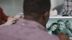 group of engineers developing facial recognition software technology using digital tablet computer brainstorming design solution sharing project ideas in busy office meeting - Powered by Shutterstock - Get 15% off with code: PIKWIZARD15