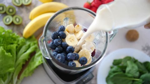 Pouring Oat Milk In Blender With Vegan Smoothie From Fruits And Berries
