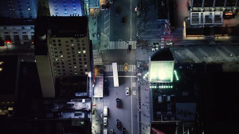 Top down aerial view of busy metropolitan streets and nightlife, New York City, dark night lighting. Wide shot on 4k RED camera.