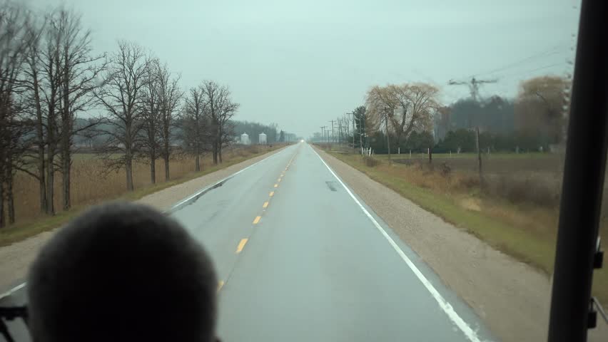 4K Close Up Bus Drivers Head While Driving Down Side Country Road On Rainy Da