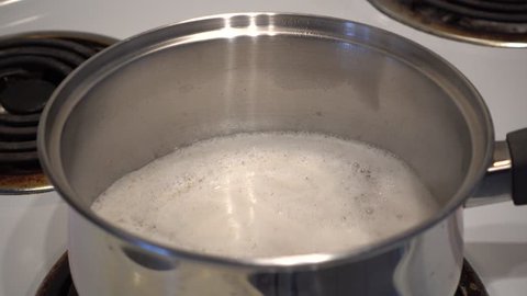 4K Pot Of Cooking Oatmeal Starting To Boil Over