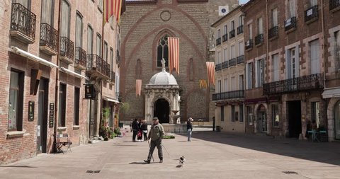 Perpignan, France - May 16, 2018: People Walking On Leon Gambetta Square And Cathedral Basilica Of Saint John The Baptist Of Perpignan In Sunny Summer Day