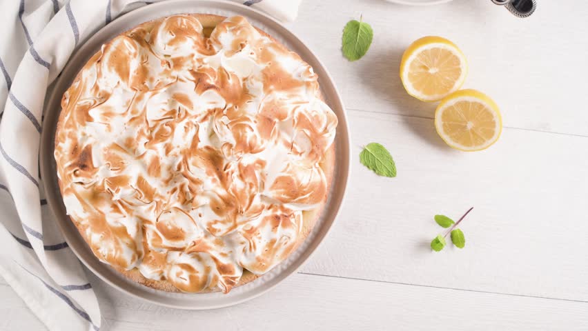 French tart with  Merengue on white wooden background. Pastry tasty homemade tart and pie with napkin.