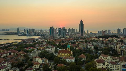 Aerial hyper lapse of Qingdao cityscape at sunset
