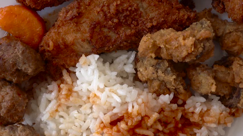 Close-up. Meat balls with rice on a rotating plate. Food and eating concepts.