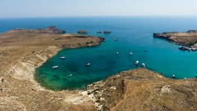Aerial view of sailing boats and yachts in the bay. Boat and yacht in the tropical lagoon. Greece, Rodos. 4K video. Travel concept
