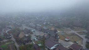 Aerial view of the preserved ancient Shirakawa village with early morning fog, Gifu Prefecture, Japan.