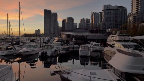 a panoramic view of the boats staying on coal harbour Vancouver Canada during the sunrise