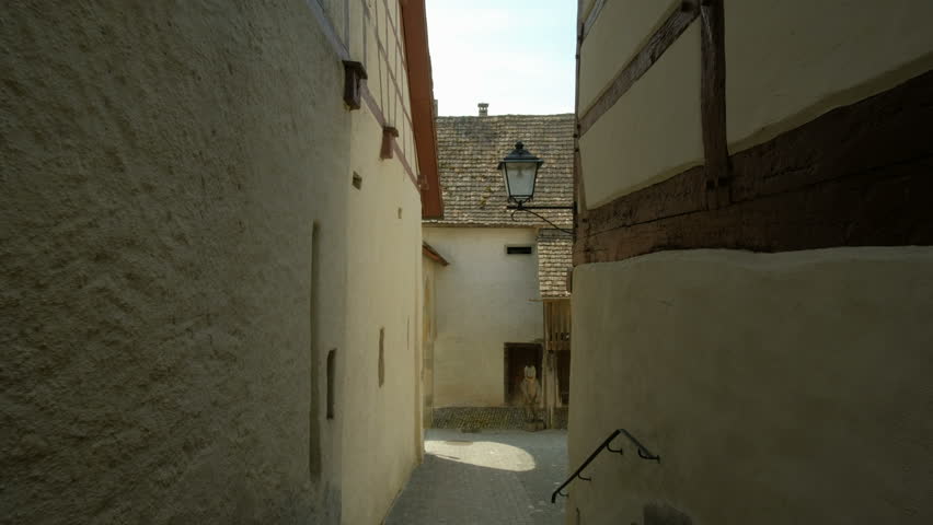 Walking between old houses down a narrow street in the town of Stein am Rhein in Switzerland.