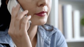 close up video of woman with pink lips talking on mobile phone. young lady joyfully discussing with family on cellphone. focus lady chatting on smartphone concept.