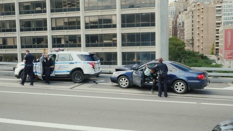 New York, USA, October 2018: Traffic accident involving a police car. Another car crashed into the parked cars, and the airbag was annoyed. The police car has a broken rear bumper