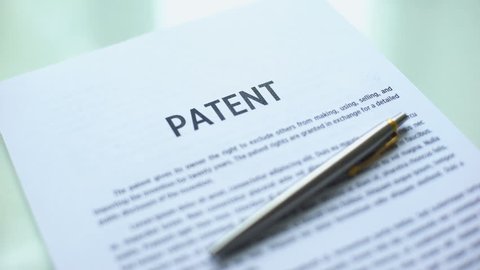 Patent document approved, hand stamping seal on official paper, copyright law
