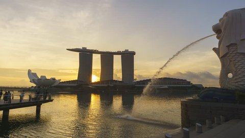 Marina Bay, Singapore - October 2018 - Timelapse of sunrise moment at Merlion Park facing Marina Bay Sands hotel. motion panning left.