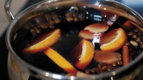 Cooking traditional drink for Christmas. Mulled wine preparations