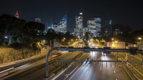 Night scene time lapse of traffic light trail to Sydney city skyline. Zoom in