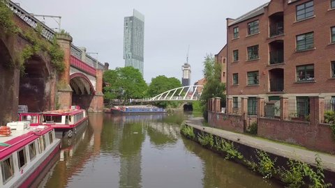  Manchester, UK - June 25, 2018:  Castlefield district, waterway canal area with a narrowboat.  Manchester UK.
