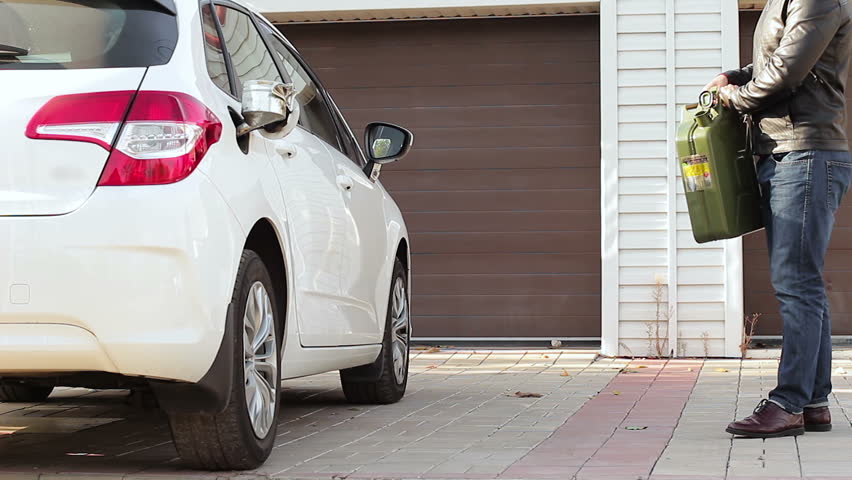 The driver fills the car with fuel from the canister itself