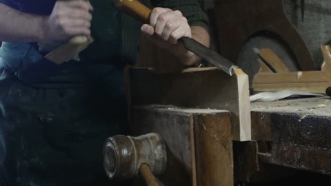 detail, carpenter uses a carpenter's chisel