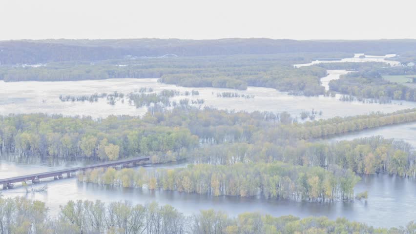 A High Angle Medium Shot of Bridges over the Flooded Mississippi and Wisconsin River Landscape in Wyalusing, WI during an Autumn Twilight 4K Timelapse