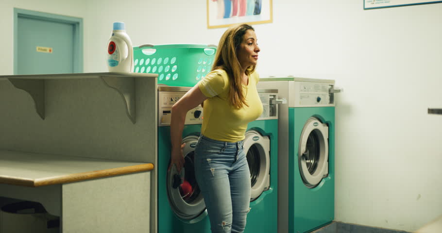 middle-aged tired woman turning washing machine Stok Videosu (%100 Telifsiz...