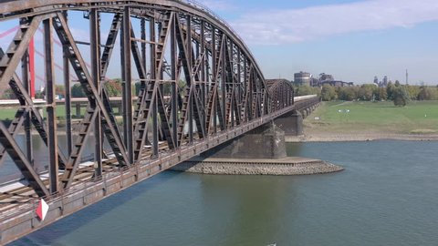 Freight Train Crossing an Iron Bridge Spanning A River for Logistics and Transportation