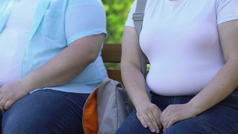 Obese man tenderly taking girlfriends hand, first date of obese couple, romance