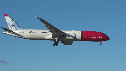 oslo airport norway - ca october 2018: norwegian airlines airplane boeing 787 9 dreamliner in flight passing slow motion freddie laker livery